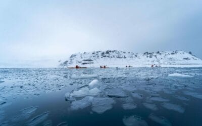 Kayaking through icy waters in Antarctica; Charlie Brooks Allen